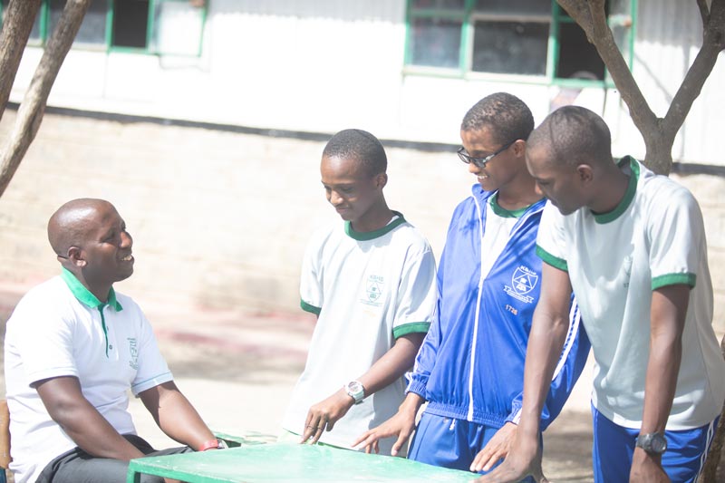 Students being mentored outside the classroom - Kitengela Boys High School, Boys Schools in Kitengela